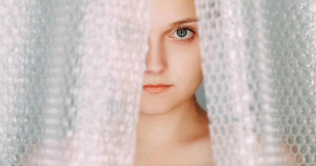 Photo plastic packaging waste worried woman bubble wrap