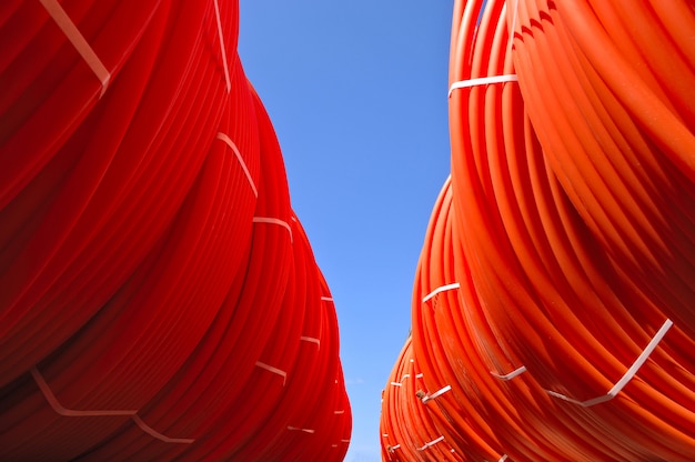 Plastic pipes stacked in rolls on the street