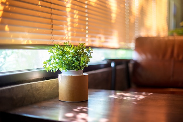 Plastic plant on wooden table for decoration at the cafe