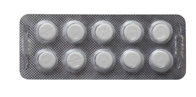 plastic plate with white pills isolated on a white background.