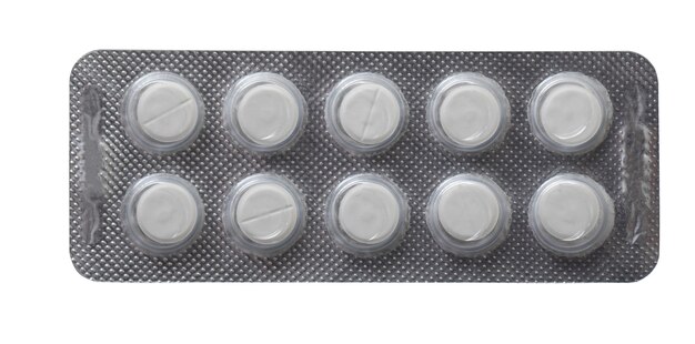 Plastic plate with white pills isolated on a white background.