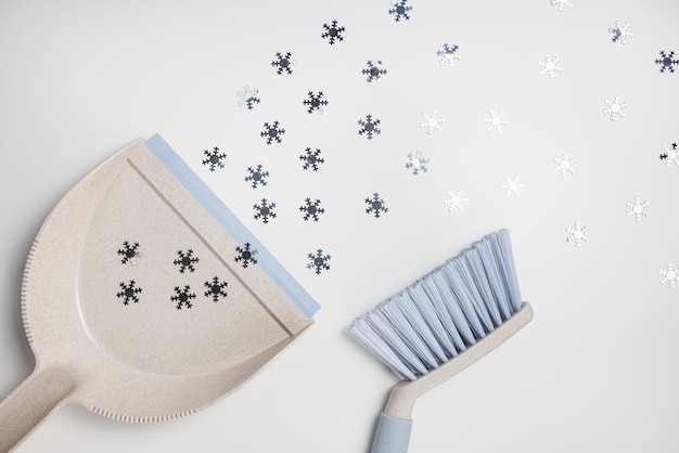 Plastic scoop set dustpan and hand brush on white festive winter background