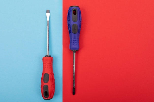 Plastic set of screw-drivers isolated on colorful background