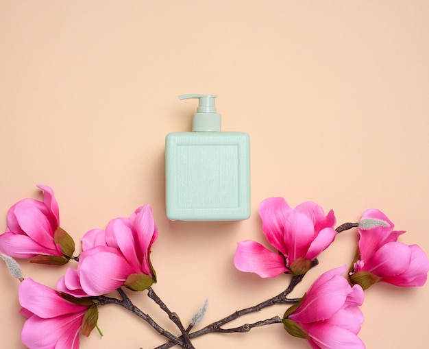 Plastic soap dispenser container on a beige background cosmetics