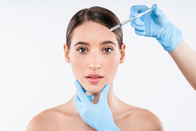 Photo plastic surgery clinicbeautiful woman gets injection in her face