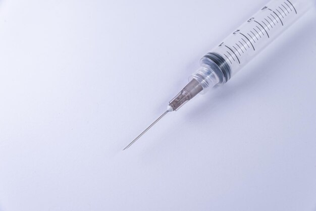 Plastic syringe on the white background