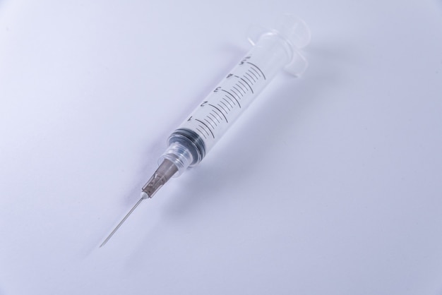 Plastic syringe on the white background