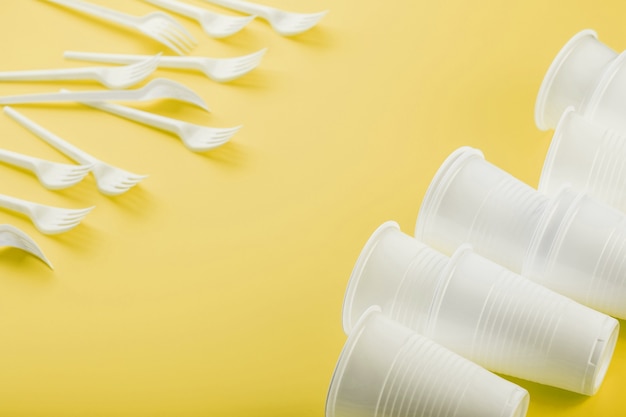 Plastic tableware on a yellow surface