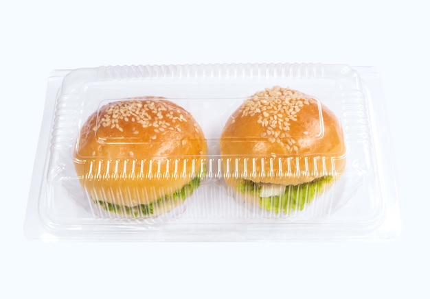 plastic take away package with two piece of small hamburgers 