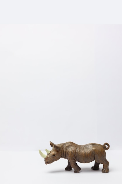 plastic toy rhino on a white background