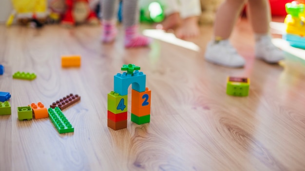 Plastic toys on wooden floor