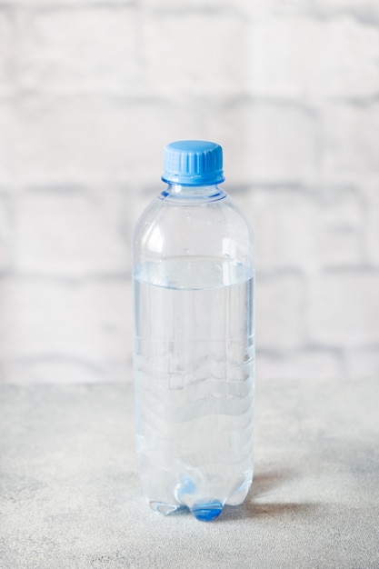 Plastic transparent water bottle on grey surface 