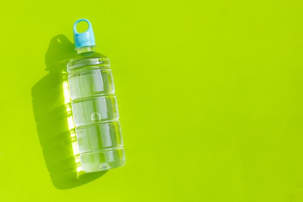 Plastic water bottle on green surface
