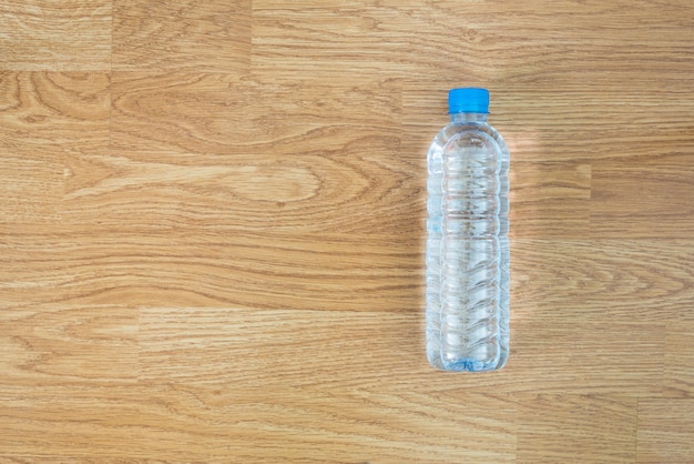 Plastic water bottle on the wooden table