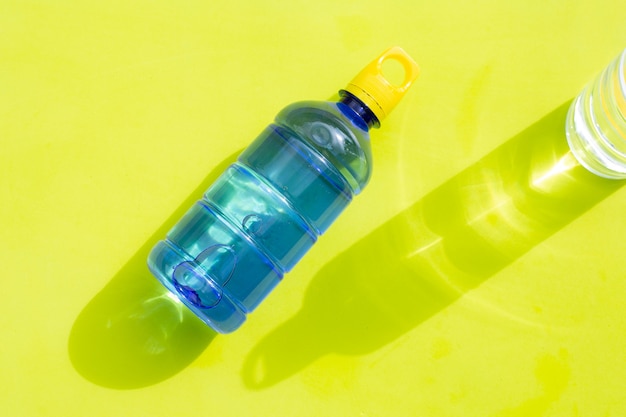 Plastic water bottles on green surface