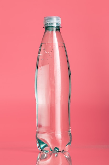 Plastic water bottles on a pastel beige background