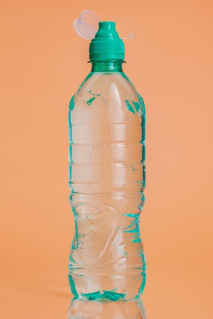 Plastic water bottles on a pastel beige background