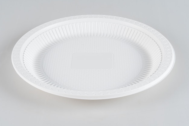 Photo plastic white plate isolated on a white background.