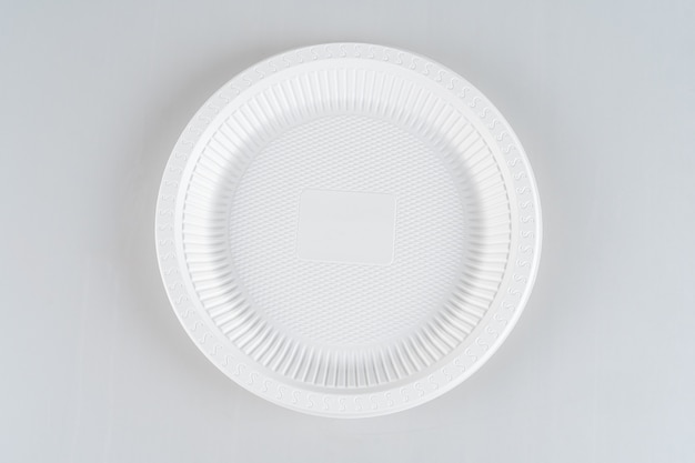 Photo plastic white plate isolated on a white background.