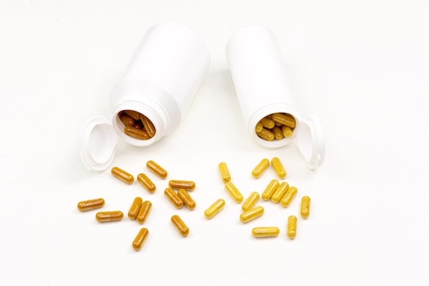 Plastic white tubes full of vitamins in pills