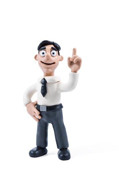 Plasticine businessman in shirt and tie raised his index finger up, close-up, isolated on white background