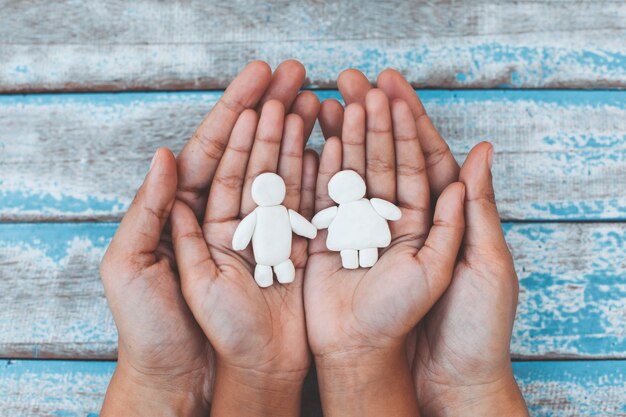 Photo plasticine clay couple on child and parents hands