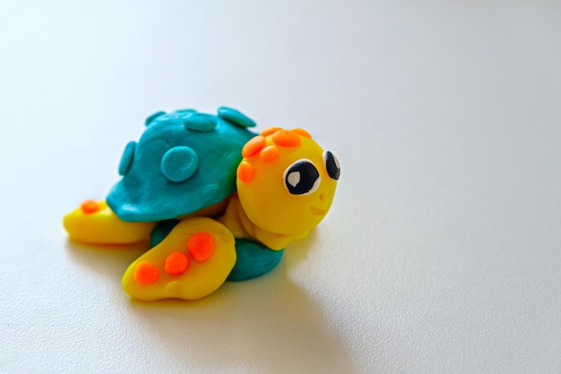 Plasticine turtle on white background children's crafts made of plasticine closeup
