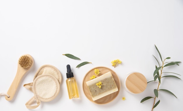 Plat lag beauty spa met natuurlijke cosmetische producten peeling natuurlijke zeep sponzen olie en massage borstels op witte achtergrond Milieuvriendelijk en nul afval concept Bovenaanzicht en kopieer ruimte