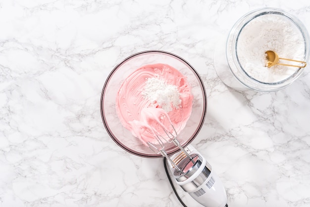 Plat leggen. Mengen in de winkel gekochte buttercream frosting in een glazen mengkom.