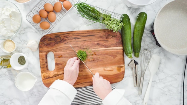 Plat leggen. Stap voor stap. Snij-ingrediënten voor het maken van courgettecakes met kruidenzure room.