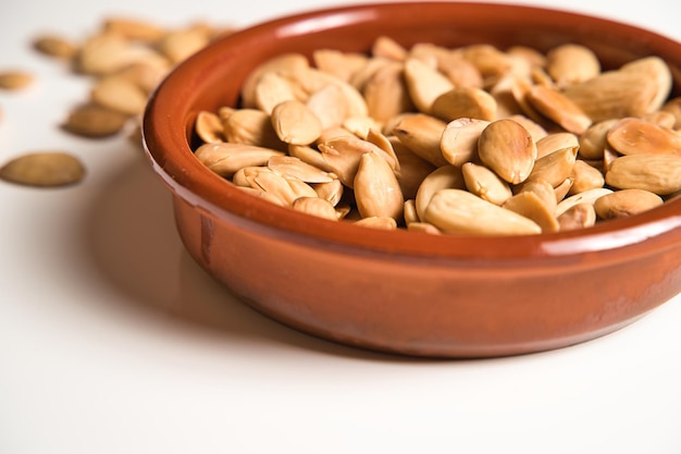 plate of almonds on white background