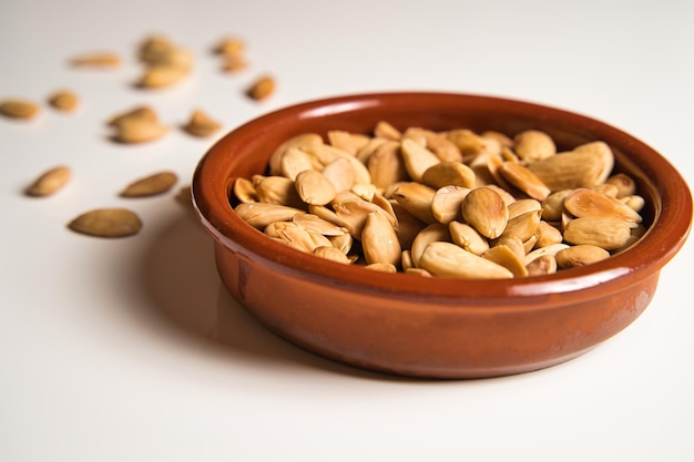 plate of almonds on white background