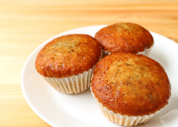 Plate of Banana Muffins Served on Wooden Table