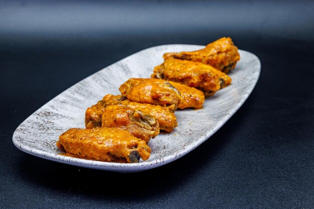 Photo plate of buffalo chicken wings on a black background