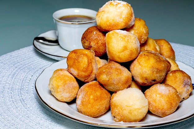 Plate of buñuelos de viento with cream and truffle typical dessert of the day of the saints