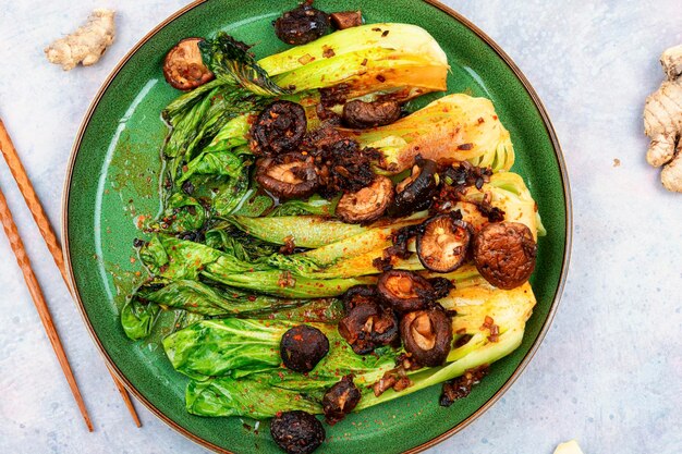 A plate of cabbage with mushrooms on it