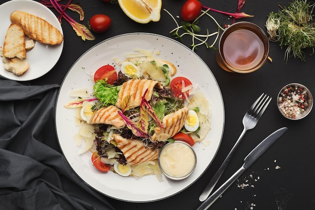 Plate of caesar salad served at restaurant, top view