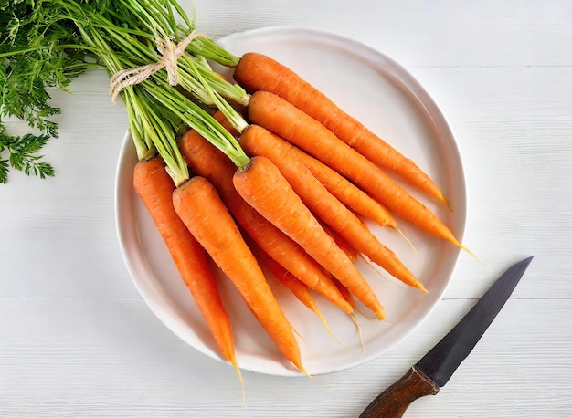 A plate of carrots and a knife are on a table
