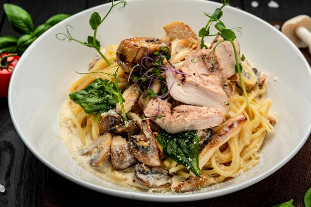 Plate of chicken pasta on a rustic wooden table