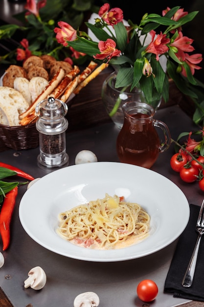 Plate of chicken pasta on a rustic wooden table.