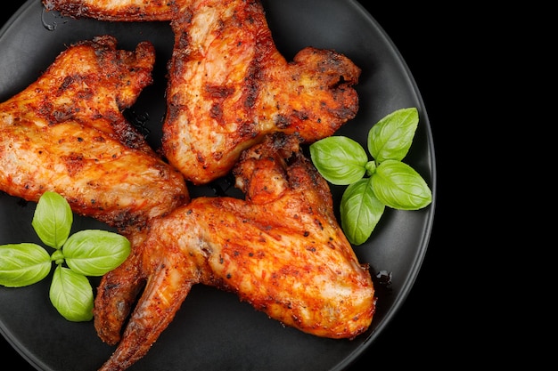 Plate of chicken wings Fried chicken on a black plate