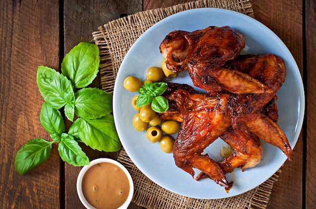 Plate of chicken wings on wooden table