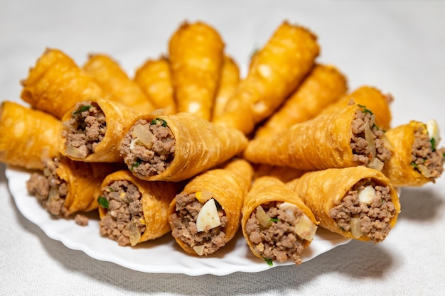 A plate of chinese food with a white cloth on the side.