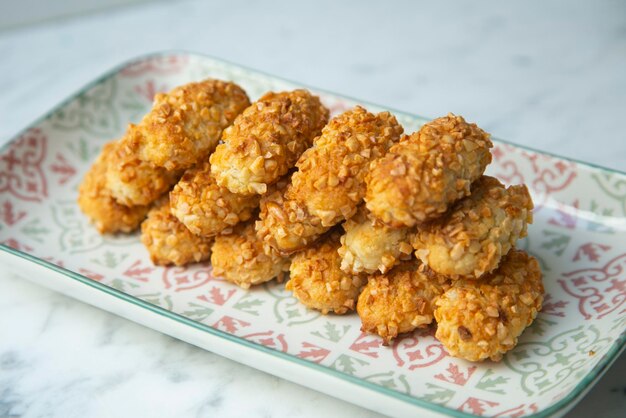 A plate of crispy chicken nuggets with a green and white border.