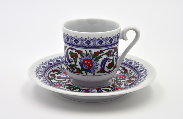 Plate and cup on a white background. turkish coffee set.\
isolated. side view. close-up.