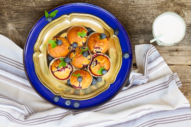 Plate of cupcakes with blueberry with milk