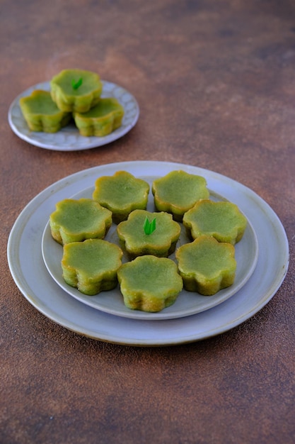 A plate of desserts with green flower on it