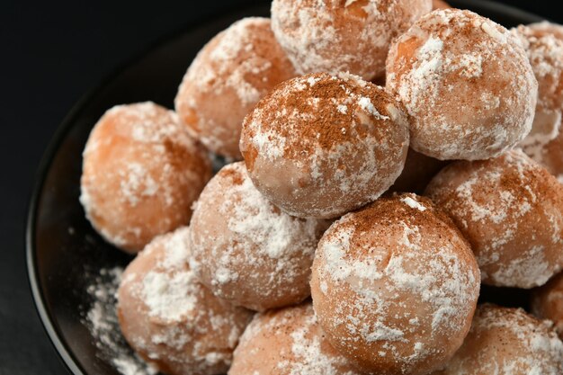 A plate of donuts with powdered sugar on top