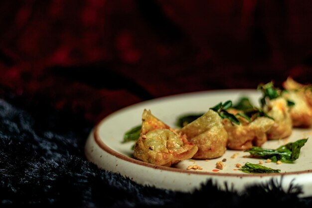 A plate of dumplings with a black background