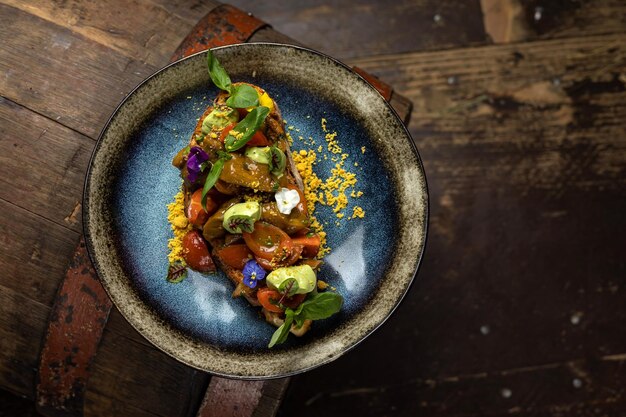 A plate of food with a blue rim and a plate of food on a wooden table.